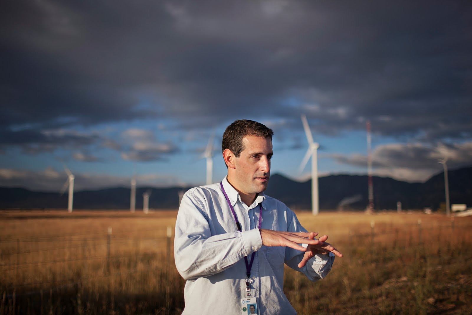 Fulbright Nexus Scholar Gabriel Preliasco in front of wind turbines