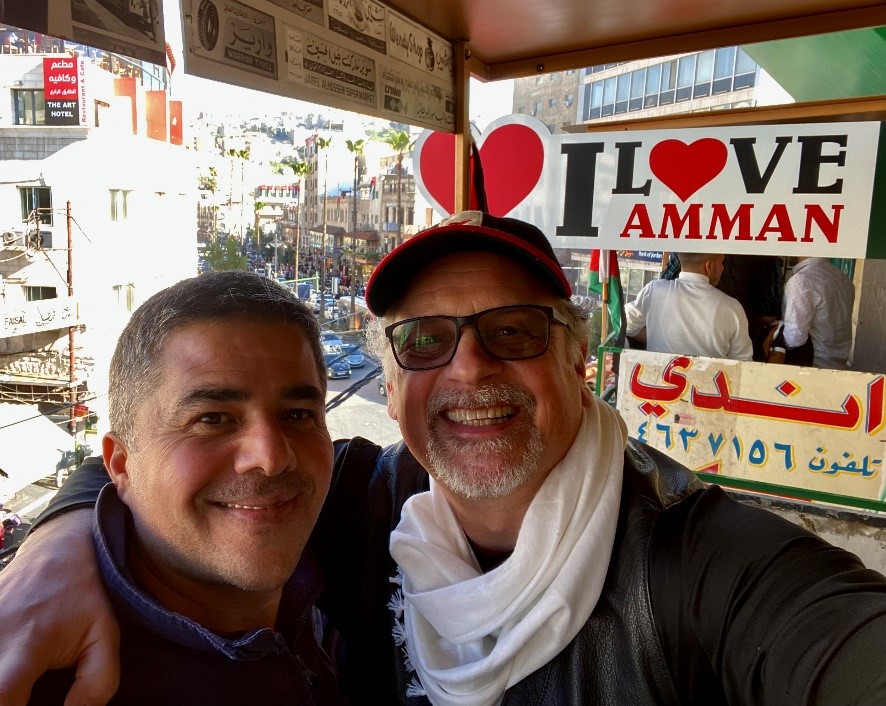 Two people standing in front of I love Amman sign