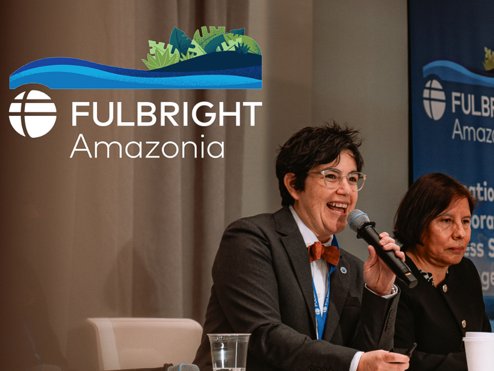 wo speakers at a panel discussion with the Fulbright Amazonia logo in the background.