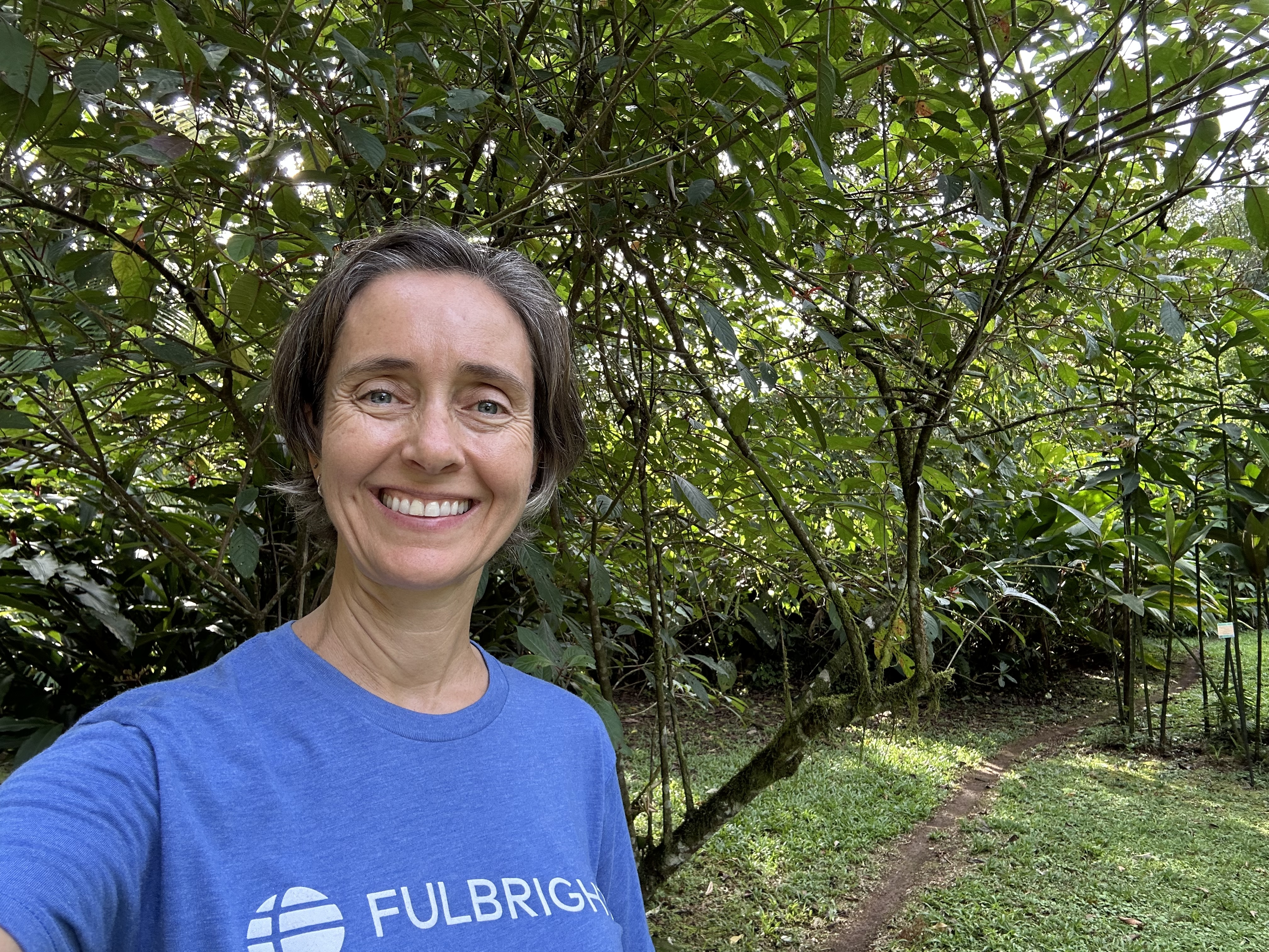 Women in Fulbright Tshirt standing in front of tree