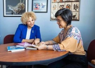 Visiting Scholar talking to faculty