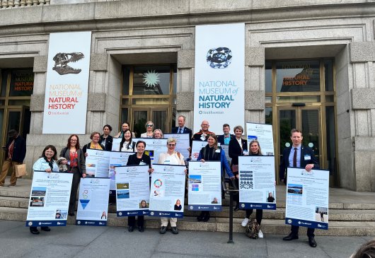 Group of people holding posters outside building